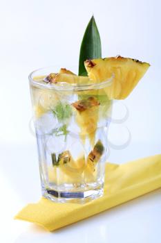 Glass of iced drink with fresh pineapple