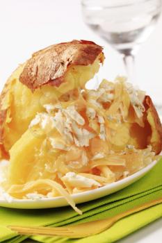 Baked potato sprinkled with two kinds of cheese