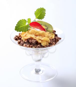 Chocolate granola and corn flakes topped with fruit