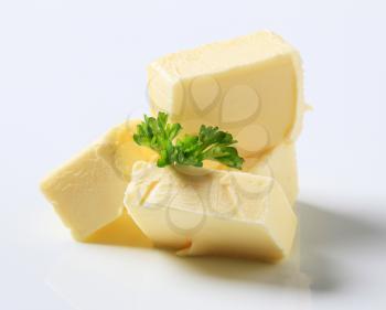 Blocks of fresh butter and parsley - studio