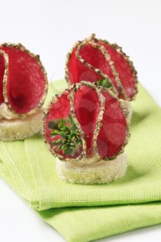 Spicy salami canapes on a green napkin