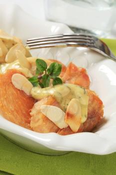 Slices of chicken breast with herb sauce and almonds