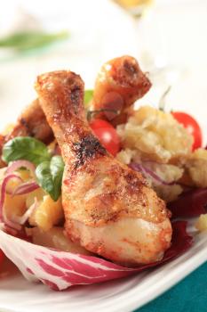 Roasted chicken drumsticks with crushed potatoes and lettuce