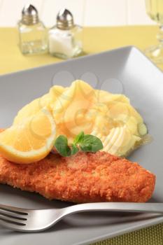 Fried breaded fish fillet with mashed potato