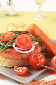 Salmon burger and fish stick with vegetable garnish