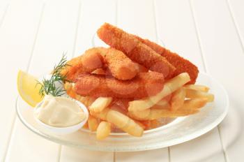 Fried fish sticks with French fries and creamy dip