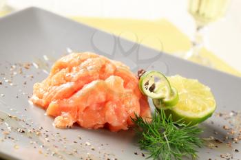 Gravlax garnished with lime, dill and seasoning