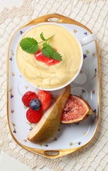 Bowl of fruit cream and fresh fruit