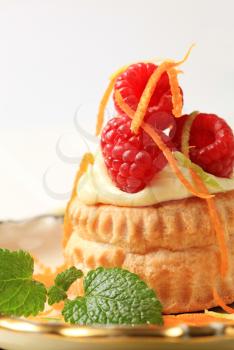 Cream filled puff pastry shell topped with raspberries