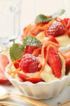Creamy pudding with fresh strawberries and raspberries