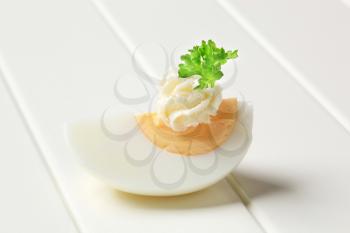 Boiled egg topped with spread and parsley