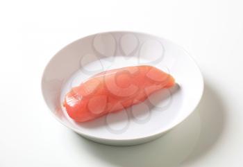 Raw chicken breast fillet on a white plate
