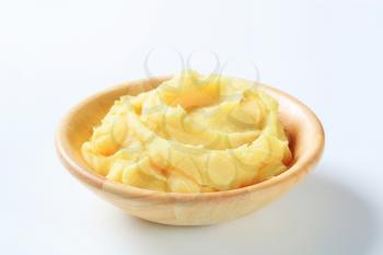 Portion of mashed potato in wooden bowl