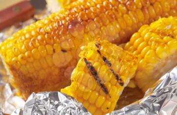 Pieces of sweet corn grilled in tin foil