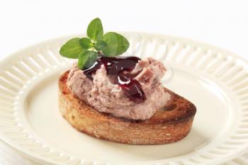 Toasted bread with pate and cranberry sauce