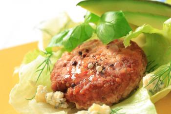 Meat patty with lettuce, avocado and blue cheese