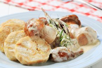 Porcini mushrooms in cream sauce served with bread dumplings