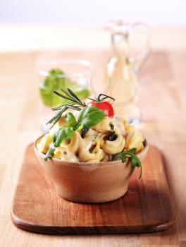 Bowl of tortellini with pesto and sauce