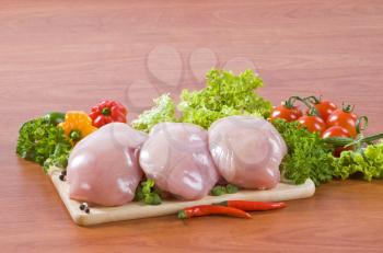 Raw chicken breast fillets and fresh vegetables
