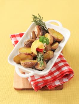 Halves of baked potatoes in a casserole dish