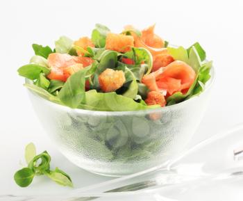 Bowl of greens with smoked salmon and croutons