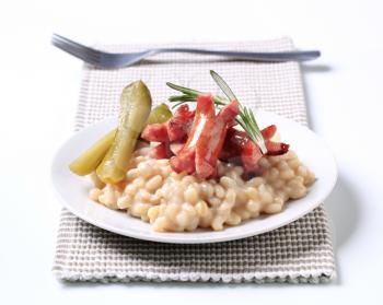 White beans with roasted sausages and pickles