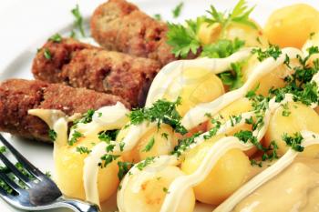 Cevapcici with potatoes, mayonnaise and mustard 