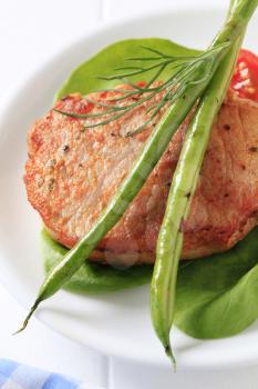 Marinated pork chop accompanied with vegetables