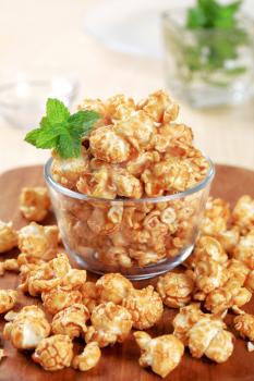 Glass bowl of popcorn coated with caramel