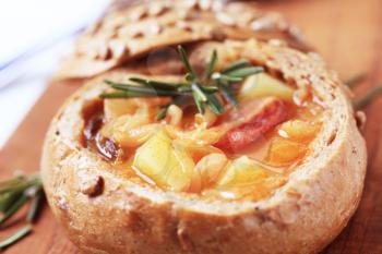 Cabbage soup with potatoes and sausage served in a bread bowl