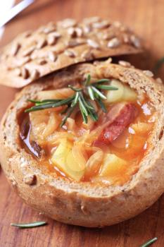 Cabbage soup with potatoes and sausage served in a bread bowl