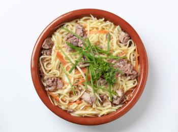 Bowl of beef soup with homemade noodles