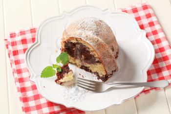 Slice of marble cake sprinkled with icing sugar