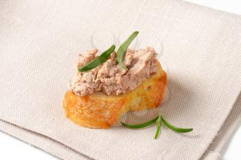 Slice of crunchy baguette with chicken liver pate