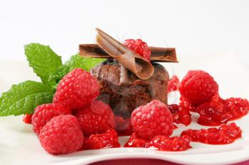 Mini chocolate cake served with fresh raspberries
