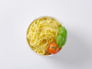 bowl of cooked spaghetti on white background