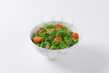 bowl of fresh rocket leaves with cherry tomatoes