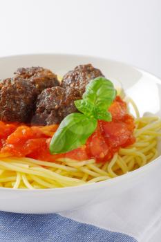 plate of spaghetti and meatballs in tomato sauce