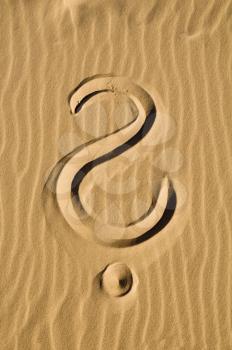Question mark in the sand - closeup
