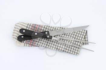 carving knife and fork on dish towel