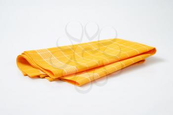 folded yellow checkered tea towel