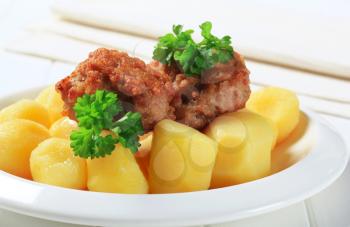 Fried meatballs served with potatoes