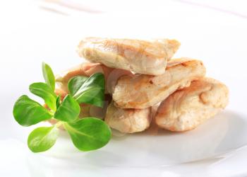 Cooked chicken breast fillets with lamb's lettuce