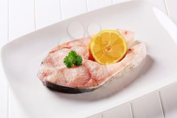 Fresh fish steak with lemon