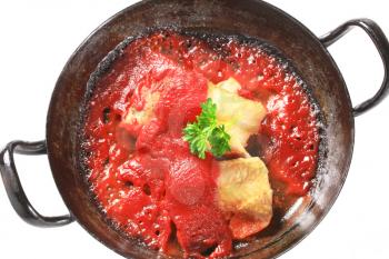 Pan fried fish fillets in rich tomato sauce 
