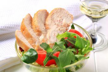 Sliced chicken breast fillet with mixed salad greens