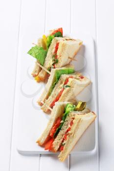 Vegetable double decker sandwiches on cutting board