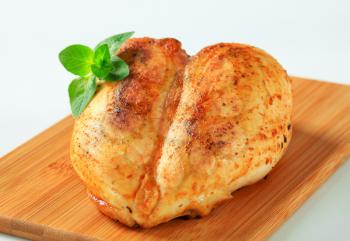 Roasted chicken breasts on cutting board