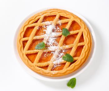 Round lattice topped apricot tart 