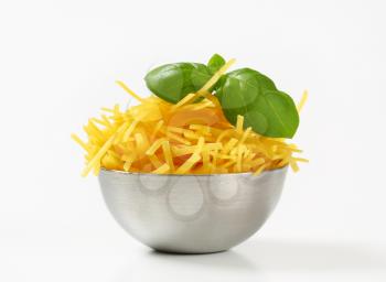 Dried egg noodles in metal bowl